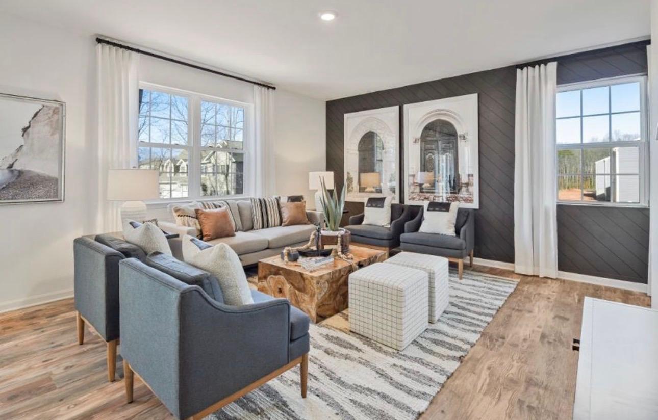 The Frederick Retreat shared living space with seating arranged around a striped area rug